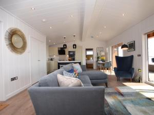 a living room with two blue couches and a kitchen at 2 Bed in Anstruther oc-72436 in Anstruther