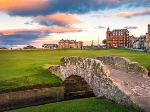 an old stone bridge over a field with buildings in the background at 2 Bed in Anstruther oc-72436 in Anstruther