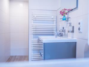 a bathroom with a sink and a towel rack at Hafensternchen in Husum +37 photos