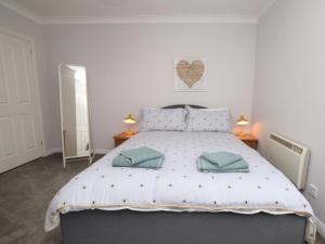 a bedroom with a bed with two pillows on it at 1 Bed in Biggar oc-82923 in Biggar