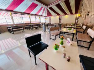 a restaurant with tables and chairs in a room at Wadi rum lacshre in Disah +70 photos