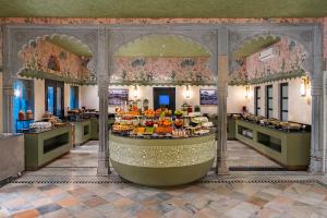 a hotel lobby with a fruit buffet in the center at lebua Udaipur Daulatgarh in Udaipur