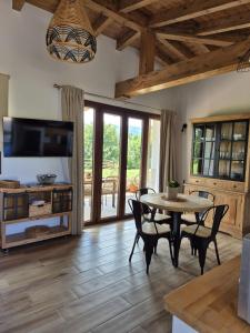 a living room with a table and chairs and a television at Terradeva Apartamentos in Colombres