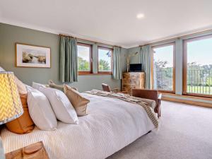 a large bedroom with a large bed with windows at 6 Bed in Perth oc-96289 in Stanley