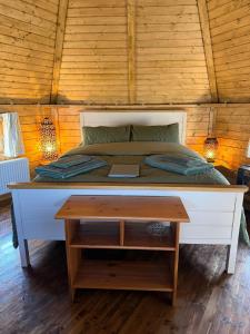 a bedroom with a bed with a table in it at The Nook Cardross in Cardross