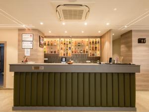 a restaurant with a green bar in a room at Hotel Rio in Siliguri +21 photos