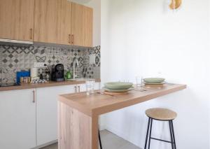 a kitchen with a counter with two bowls on it at L'espace de Robespierre in Saint-Denis