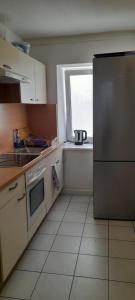 a kitchen with a stainless steel refrigerator and a window at Ela Gar 1 WG Zimmer Wohngemeinschaft in Garsten