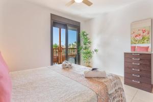 a bedroom with a large bed and a balcony at Ojos del Océano in Palm-Mar +26 photos