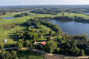 an aerial view of a house on a hill next to a lake at Lillium in Merķeļi