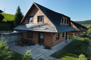 a wooden house with a gambrel roof at Zrub pod Roháčmi in Zuberec