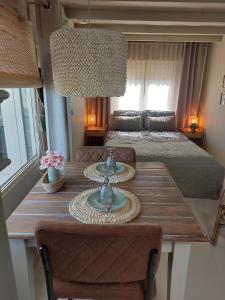 a room with a table with a bed and a bedroom at Knus Tiny house 2 pers rust natuur en privacy in Borger