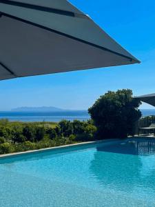 a swimming pool with a view of the ocean at Vista Mare , Cap corse in Meria