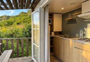 a kitchen with a balcony with a view at Vista Mare , Cap corse in Meria