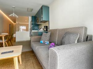 a living room with a gray couch and a table at Casa Arno - Lovely Renovated Apartment In Playa De Mogan in Puerto de Mogán