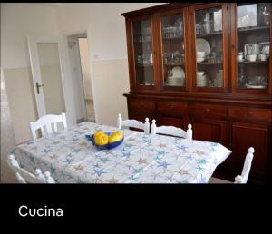 a dining room table with a bowl of fruit on it at Grande Procida in Procida