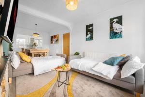 a living room with a couch and a table at Delves House in Bescot