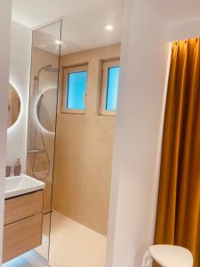 a bathroom with a shower and a sink at Villa la Hune- Proche Golfs & Plage in Neufchâtel-Hardelot +26 photos
