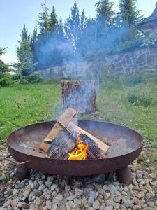 a fire pit with wood and flames in it at Zrub pod Roháčmi in Zuberec +24 photos