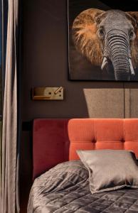 a bedroom with a picture of an elephant on the wall at Pulli Country Club - Private Sauna & River View in Pärnu +12 photos