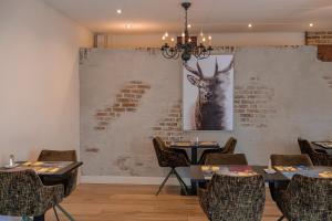 a restaurant with a picture of a deer on the wall at Hotel Atlanta in Valkenburg
