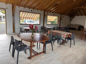 a dining room with tables and chairs and a couch at Résidence Fleur de Café - Petite Terre in Deshaies