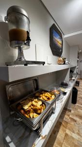 a counter in a kitchen with some food on it at Riacho Hotel in Brasília