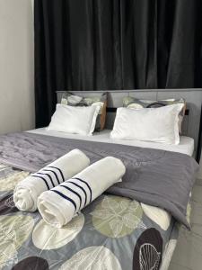 a pair of beds with pillows and blankets on them at West Side Résidence in Dakar +18 photos