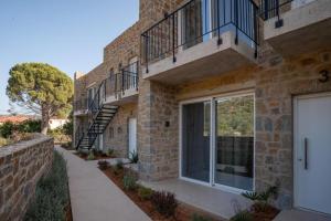 a brick building with balconies and a sidewalk at Apartment Athina with direct pool access - GH8 in Gialova