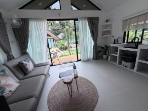 a living room with a couch and a table at Good Mood Bungalows in Ko Phangan +52 photos