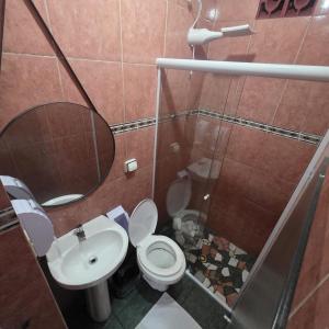 a bathroom with a toilet and a sink and a shower at Arion Hotel Sapopemba in São Paulo