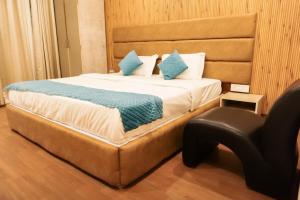 a bedroom with a bed and a chair in it at Agonda Junction in Agonda