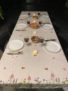a table with plates and wine glasses on it at Bel air in Les Hauts-Geneveys +6 photos