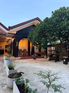 a house with a courtyard with trees in it at Astra Tourist Inn near Airport with high speed free Wifi in Puerto Princesa City