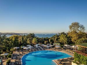 an overhead view of a pool with umbrellas and chairs at Swissotel The Bosphorus Istanbul in Istanbul