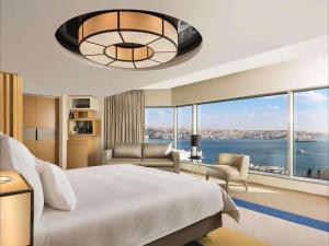 a bedroom with a large bed and a large window at Swissotel The Bosphorus Istanbul in Istanbul +139 photos