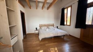 a bedroom with a bed in a white room at Chambres d'Hôtes de Marchet in Auvillar +23 photos