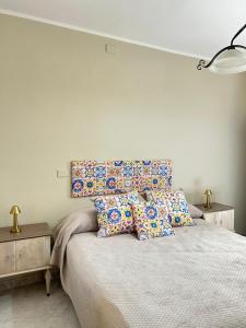 a bedroom with a large bed with pillows on it at La Casa del Sole in Corleone