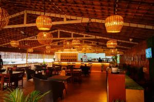 a restaurant with tables and chairs and chandeliers at Agonda Junction in Agonda +38 photos