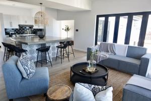 a living room with a couch and a table at Chintsa Oceanfront in Chintsa