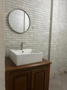 a bathroom with a white sink and a mirror at PaddyView Hostel in Banyuwangi +54 photos