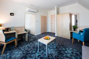 a room with a table with fruit on it at Hotel Eureka in Sopot