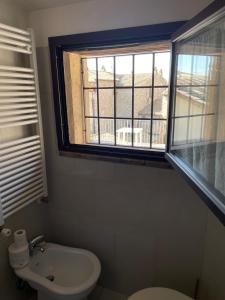 a bathroom with a toilet and a window at Arcangelo SUITE in Assisi +78 photos