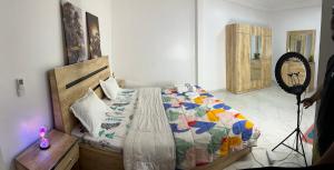 a bedroom with a bed with a colorful quilt at West Side Résidence in Dakar