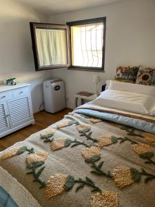 a bedroom with a bed with a blanket on it at Arcangelo SUITE in Assisi