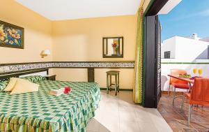 a hotel room with a bed and a table at BLUESEA Puerto Caleta in Caleta De Fuste