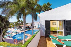 a view of the pool from the balcony of a resort at BLUESEA Puerto Caleta in Caleta De Fuste