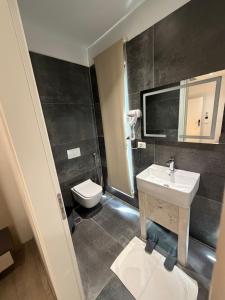 a bathroom with a sink and a toilet at Leon Hotel in Kashari +14 photos