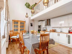 a kitchen and dining room with a table and chairs at 4 Bed in Pitlochry oc-ca274 in Foss