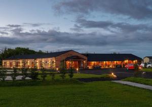 a large building with a car parked in front of it at Finest Retreats - Silverwood Junior Chalet in Errol
